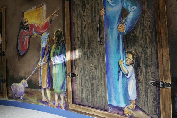 Rather than decorate the children's center with pop-culture images, church leaders chose to portray scenes from the Bible, hoping to  engage children in the gospel in a new way.