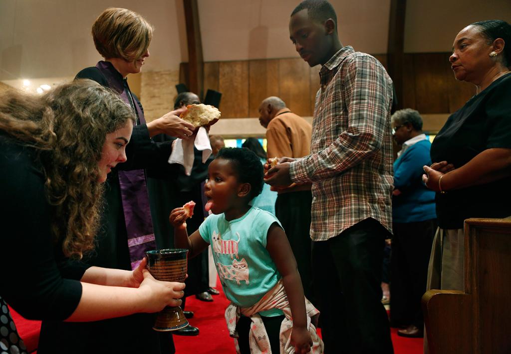 Rehabu Mukanya and her brother Vianney receive communion.