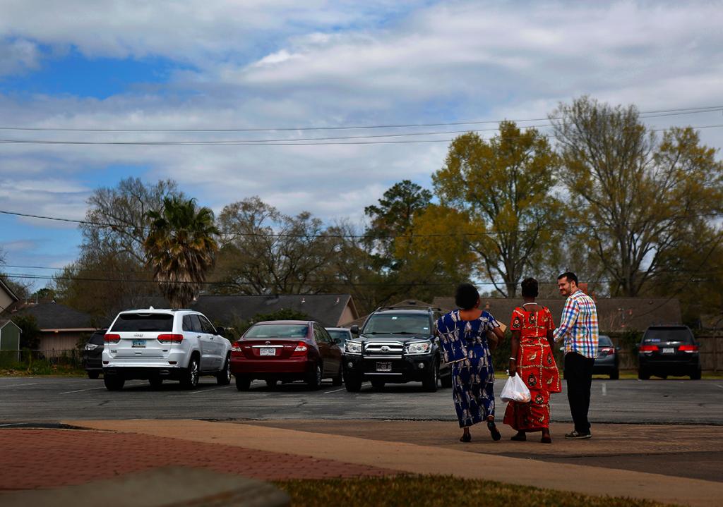 Nusura Mtendamema, Feza Mukagatare and Andrew Kragie visit on the way to the parking lot after Sunday worship.