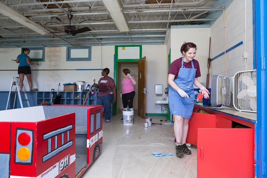 Staff and volunteers work at the Save A Youth building.