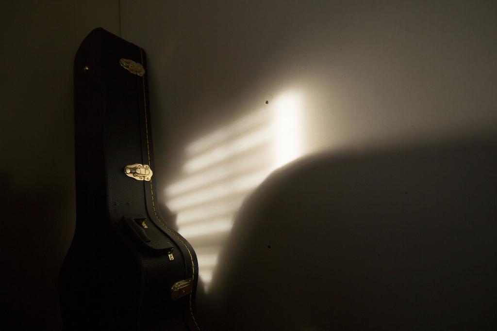 Early morning sunlight on Mack's guitar case, which his widow, Fran, keeps in her living room.