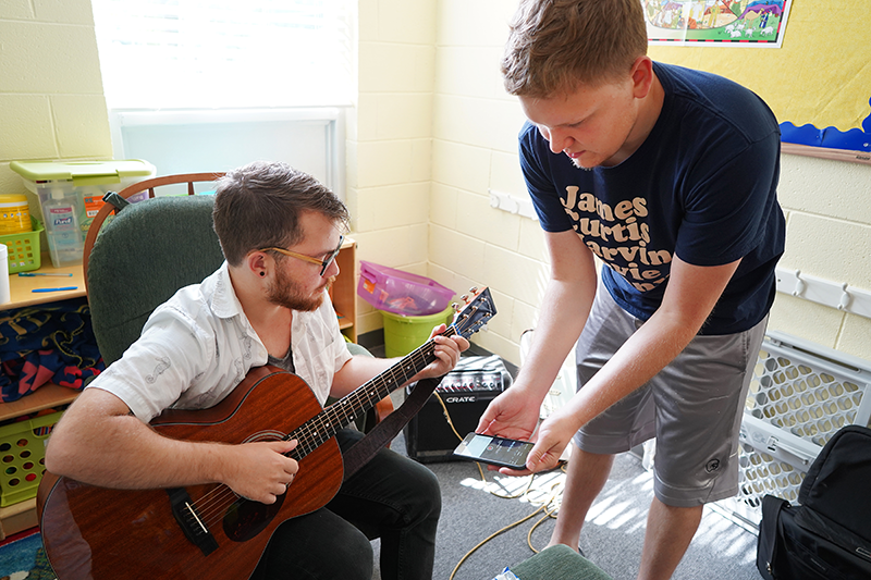 Chipper Via on guitar and Ian Schwegal on smartphone polish an original composition.