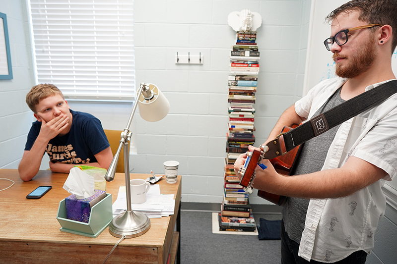 Ian Schwegal listens as Chipper Via plays a slightly revised version of a song-in-progress.