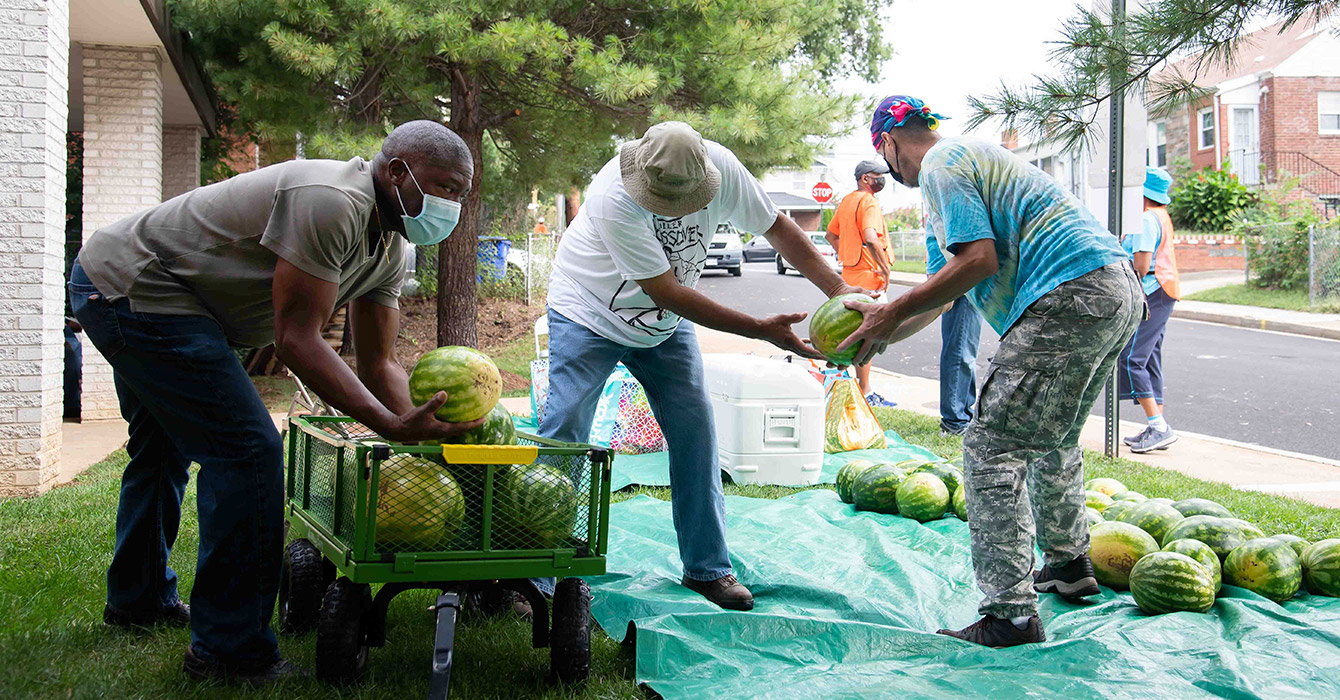 men unload watermelons