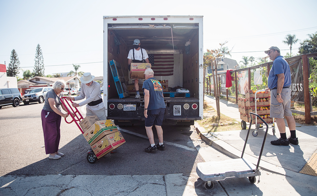 volunteers unload a truck