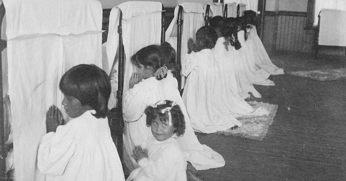 children praying next to their beds