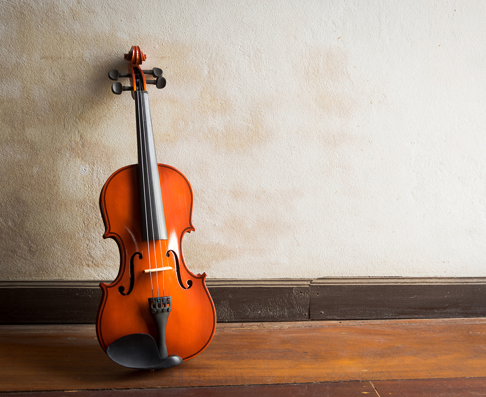 violin leaning against a wall