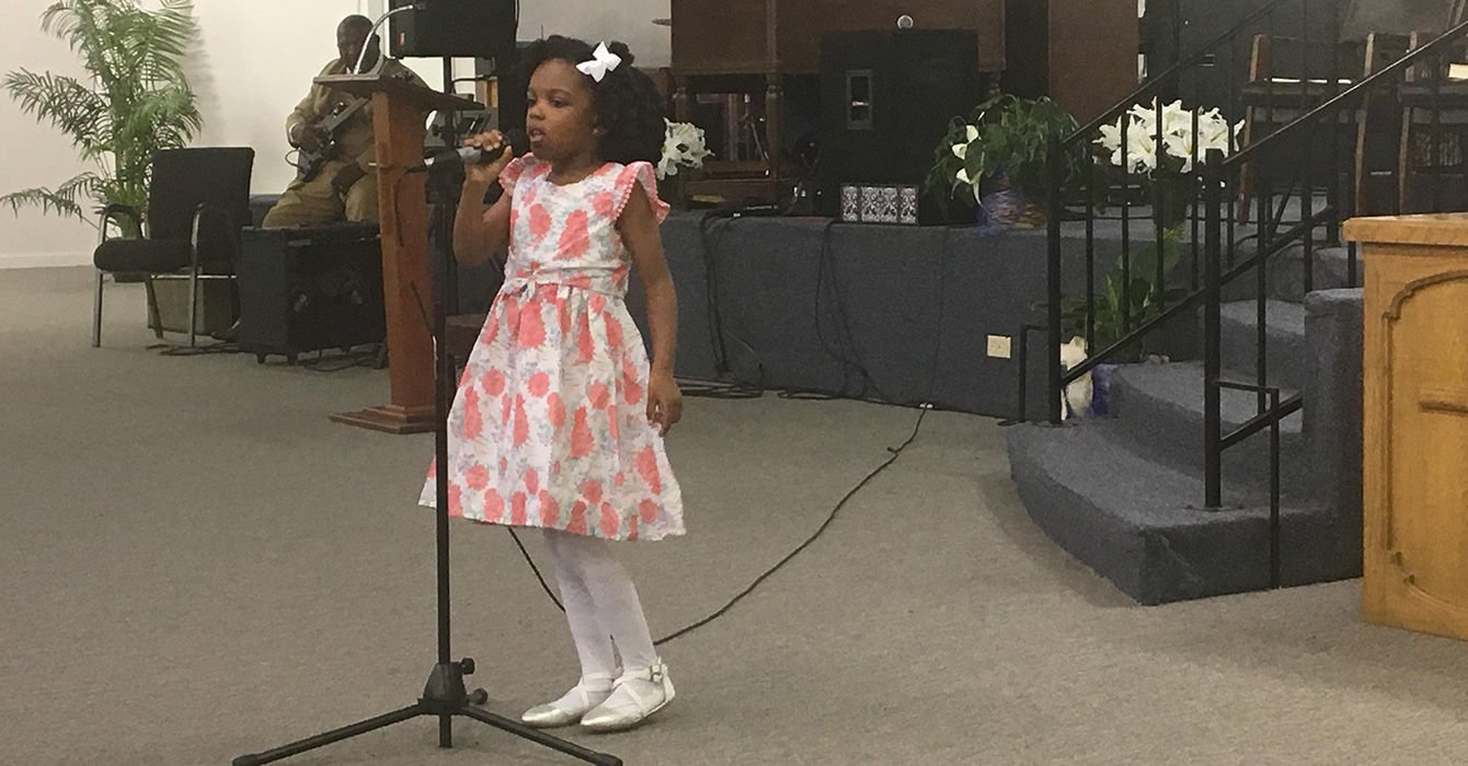 photo of a girl speaking in church