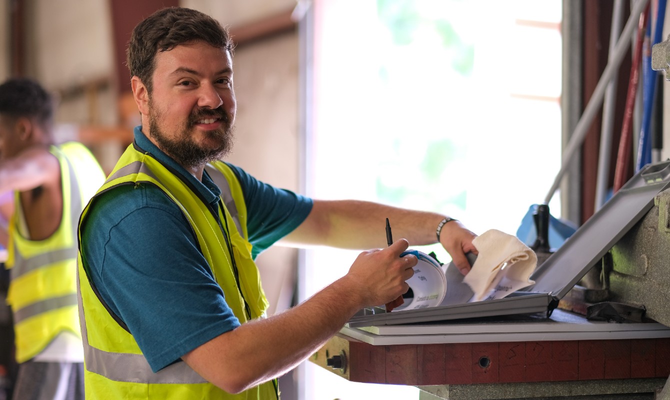 Image of a man working at a laptop