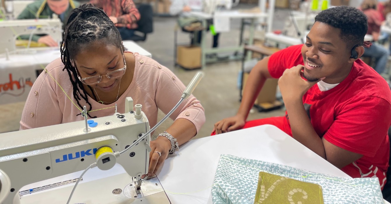 woman teaching a student how to sew