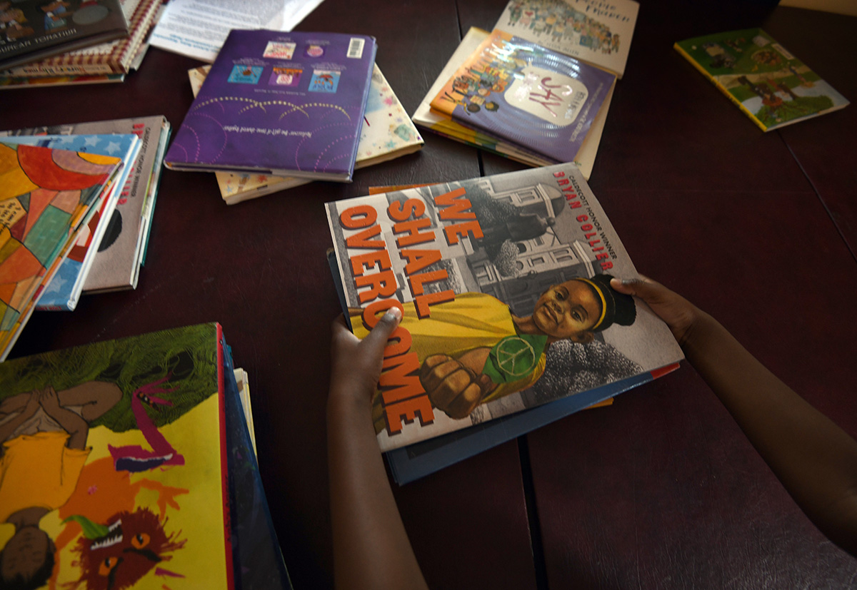 child holding books