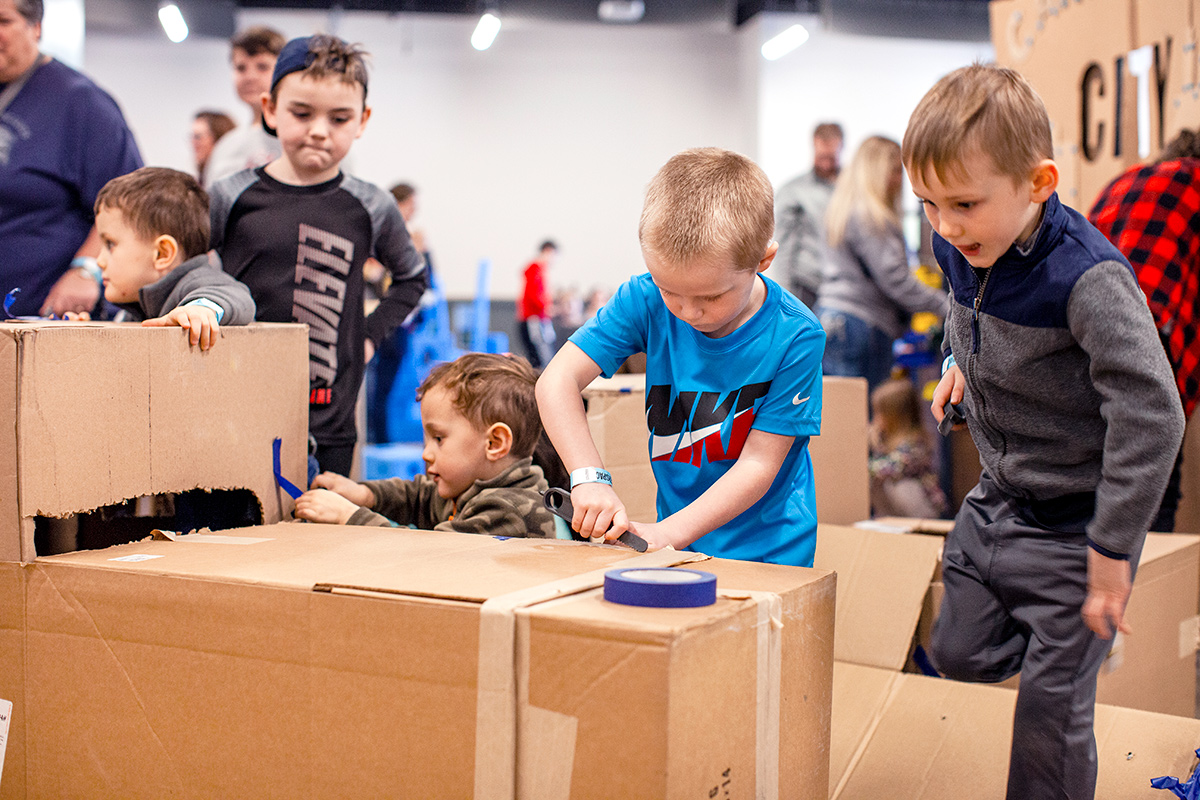 children building with cardboard