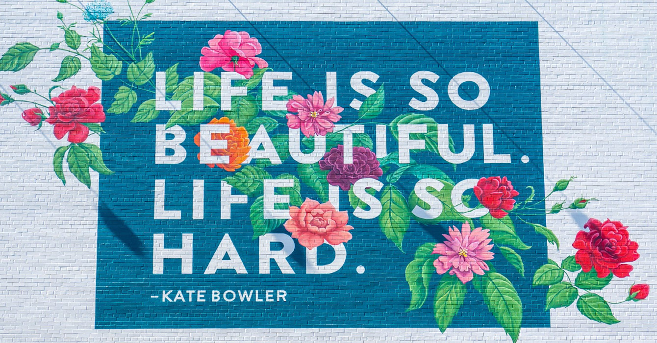 an image of a mural that says "Life is so beautiful. Life is so hard."