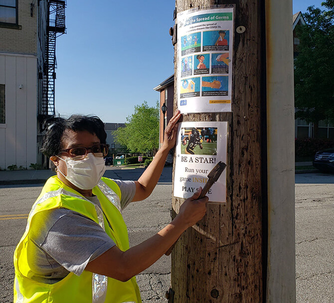 Putting up posters on telephone pole