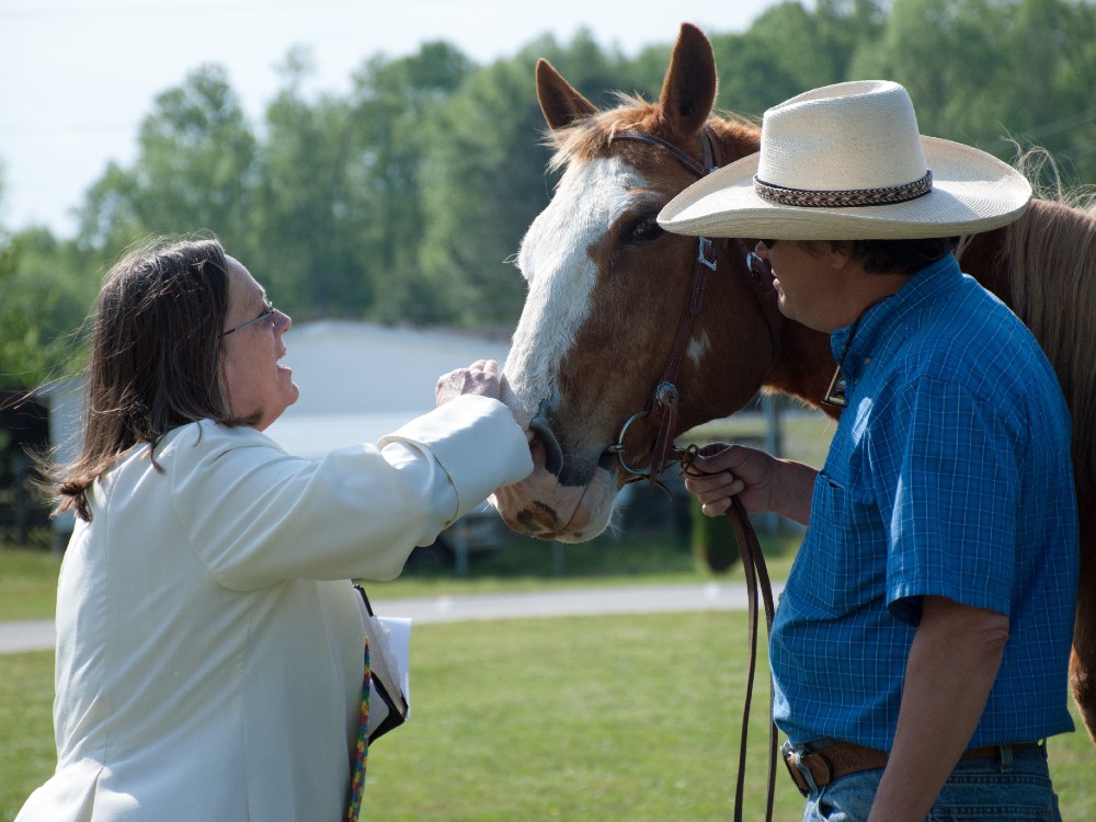 Image of woman blessing a horse