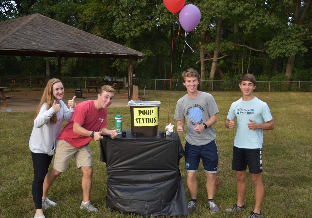 Image of a group of kids around a trash can