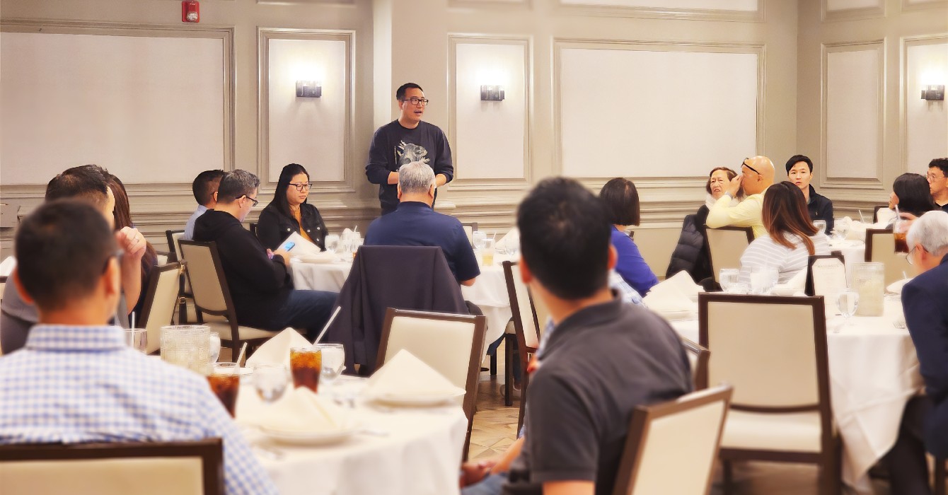 Image of people listening to a person speaking