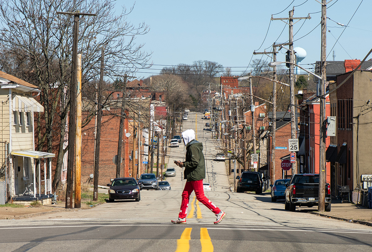 a man walks across the street