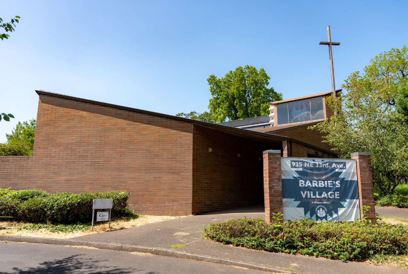 image of a brick church with a sign that says "Barbie's Village"