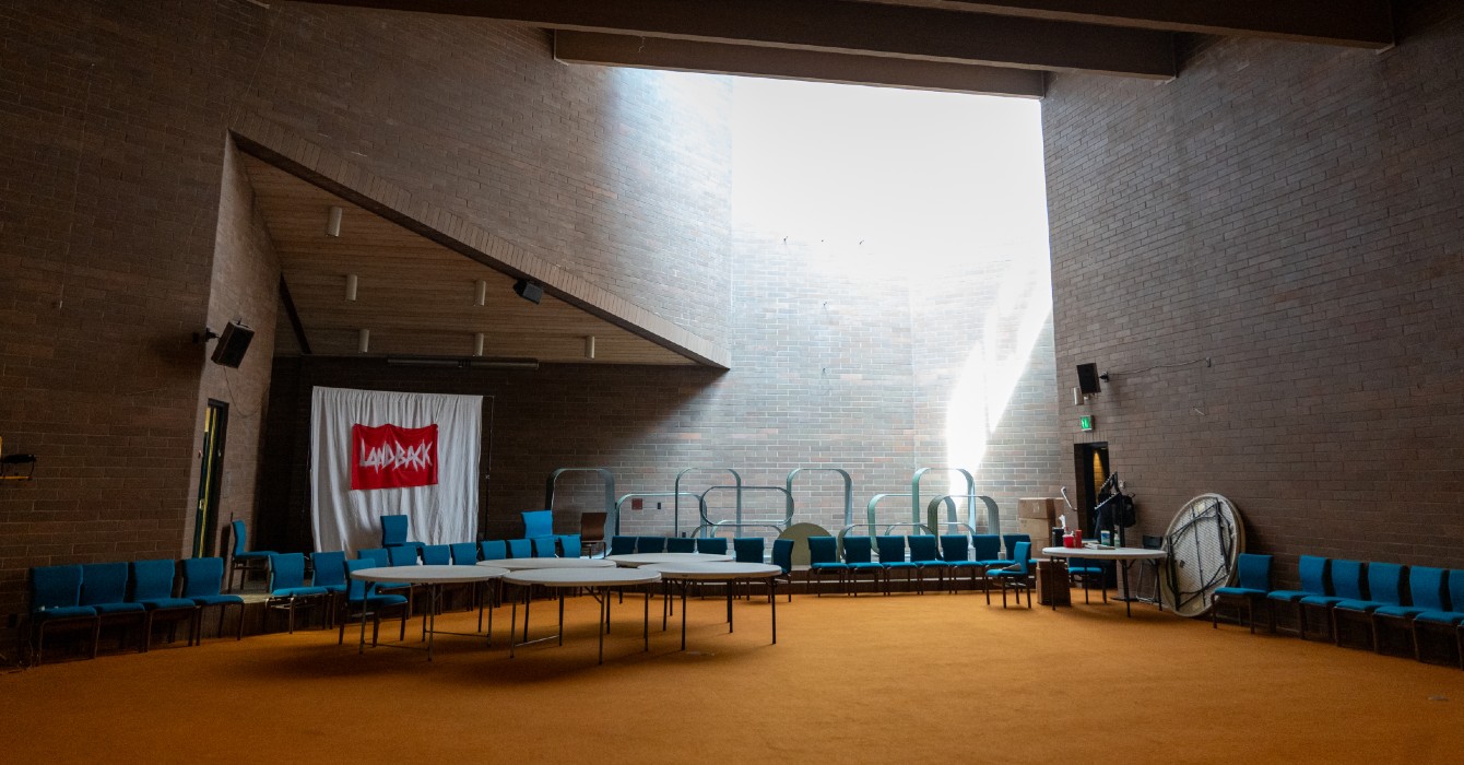 image of a sanctuary with a sign that says "Land Back"