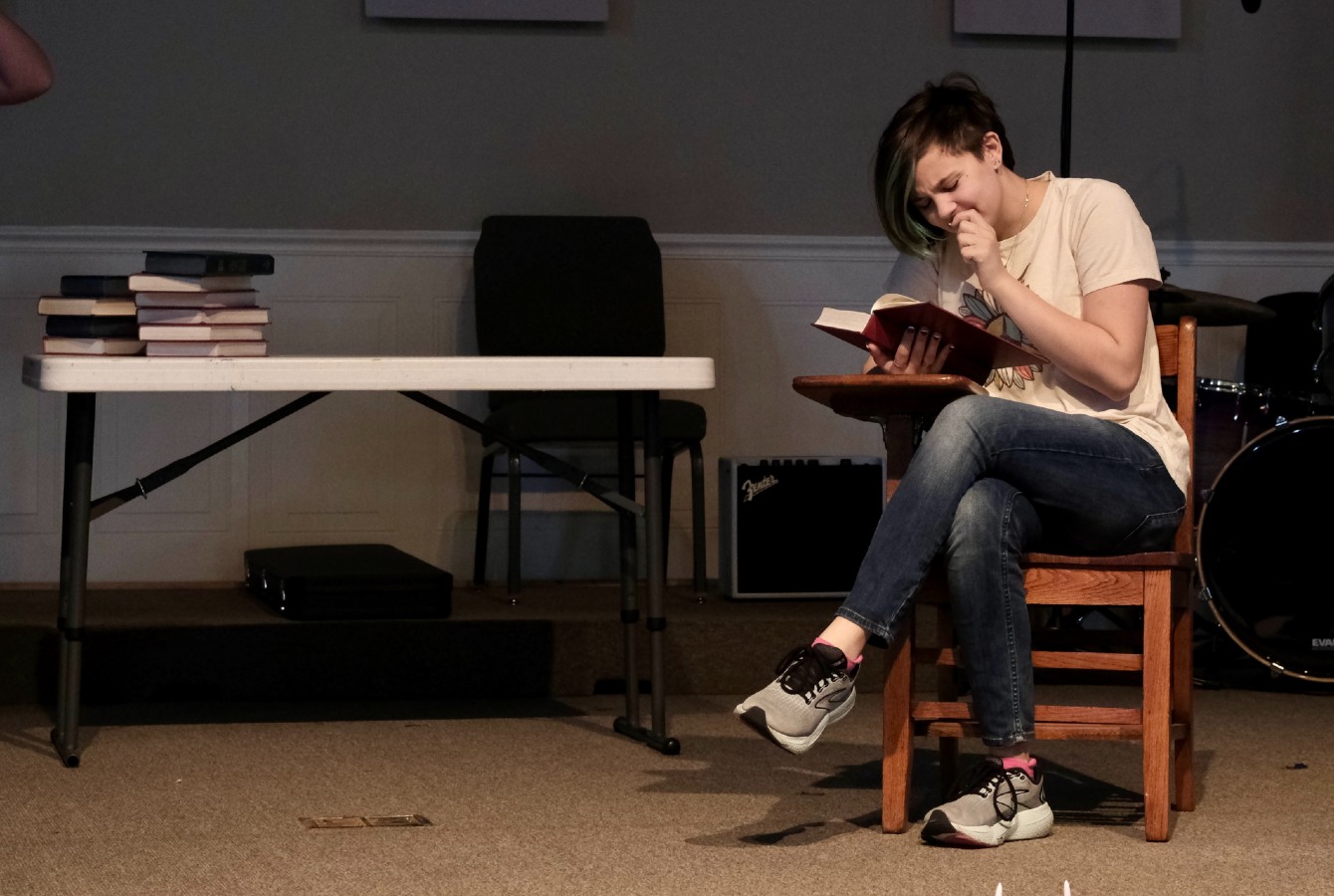 Image of an actor reading a book