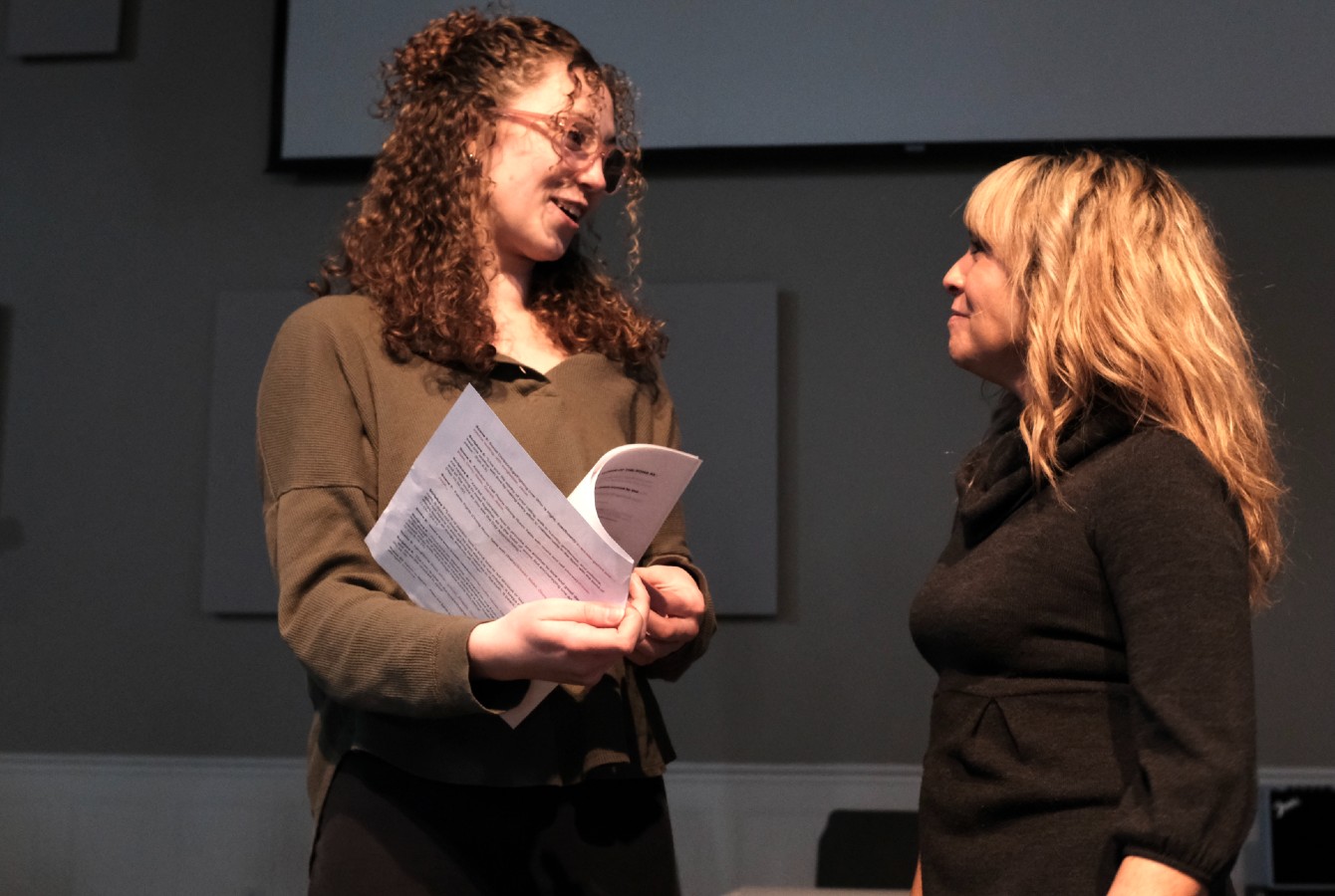 Image of a woman giving directions to a performer