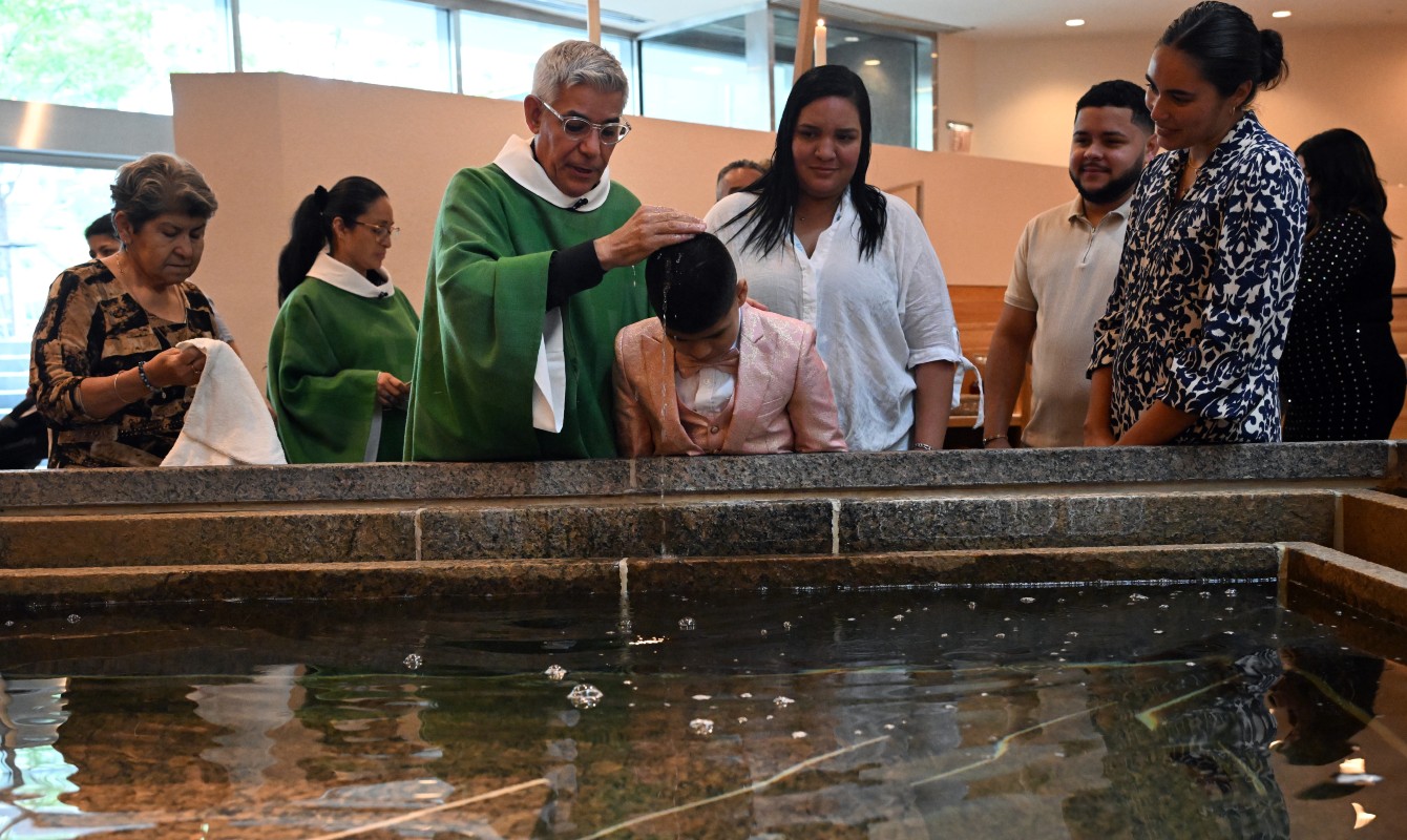 Image of a priest baptizing a child