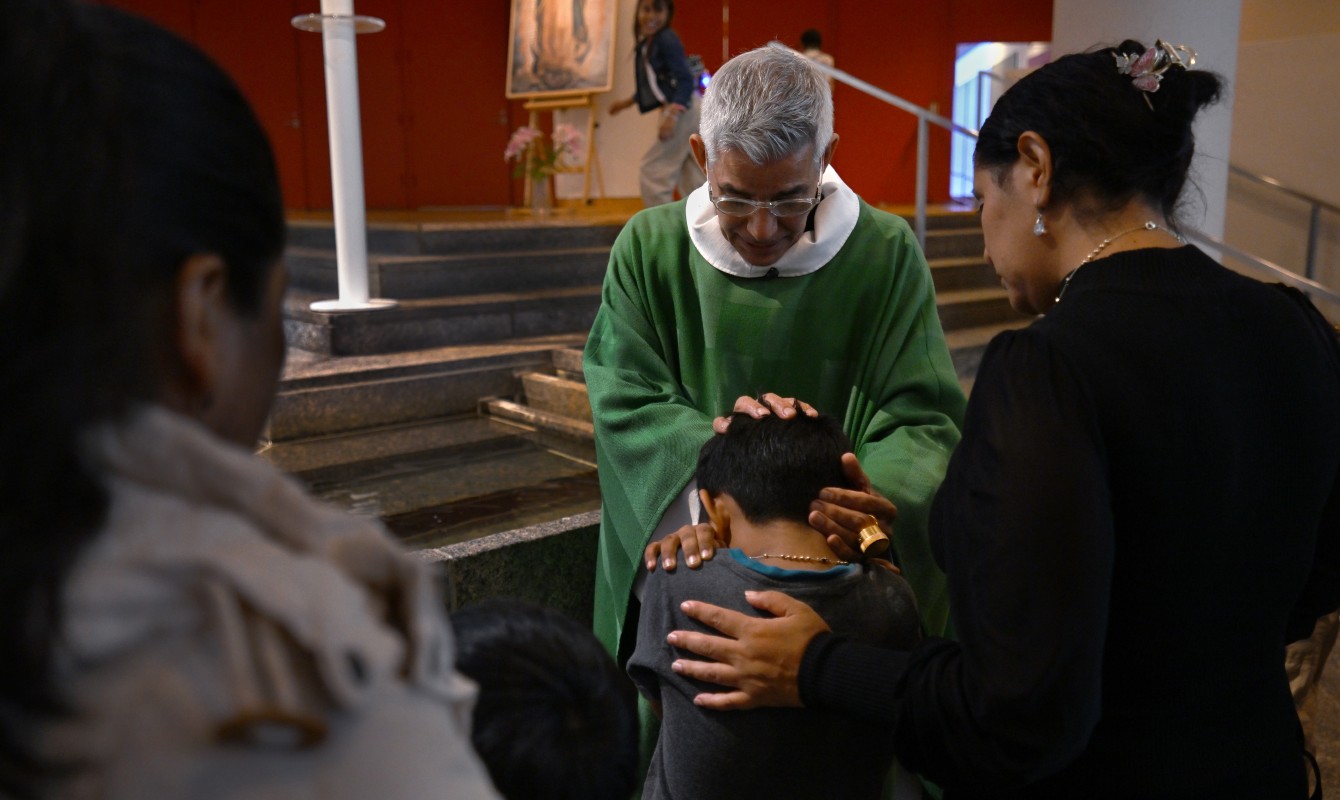 Image of a priest blessing a child