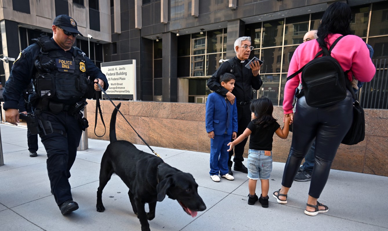 Photo of a family next to a federal official with a dog
