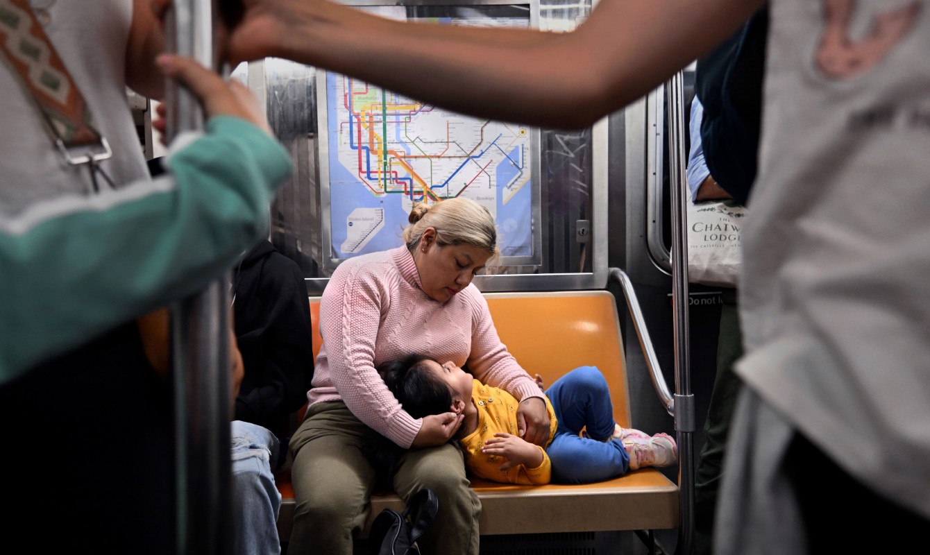 Photo of a woman on a train with her child
