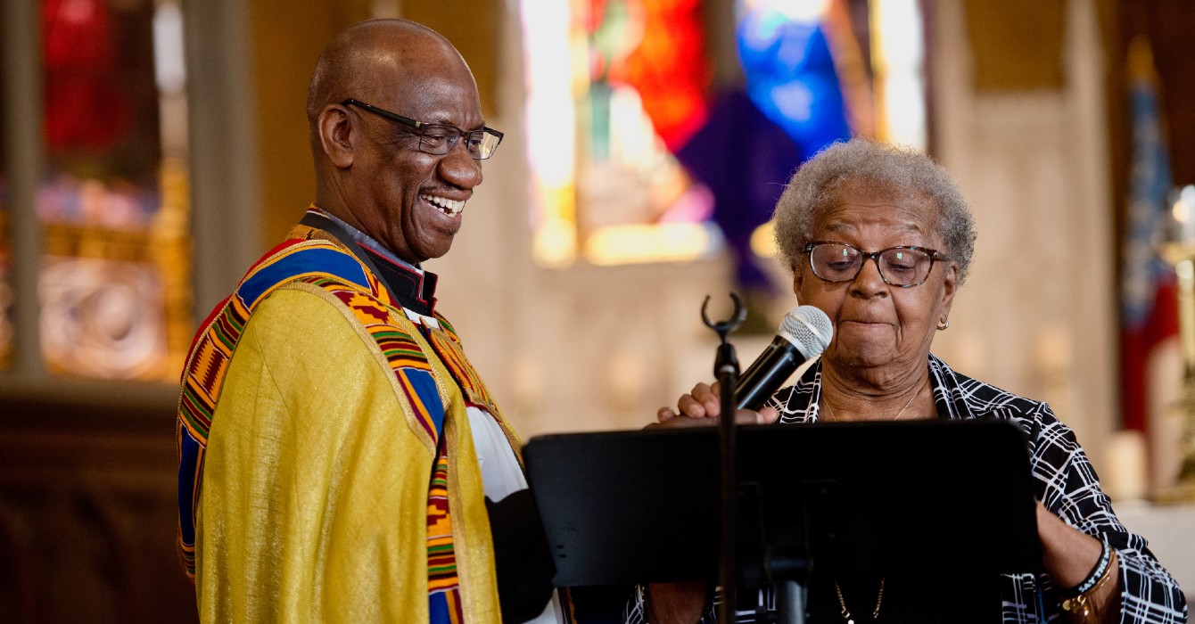 photo of two people speaking in front of a congregation