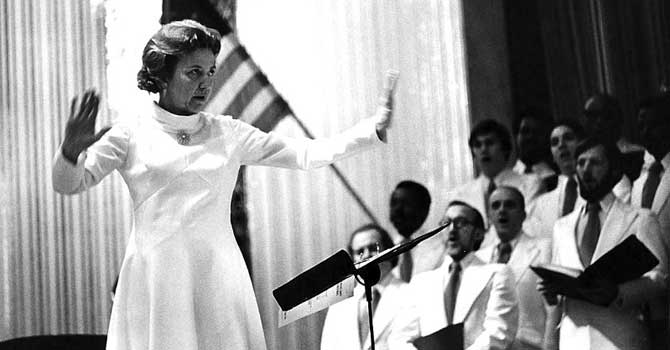 Black and white photo of woman directing a church choir