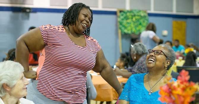 Kuhnekt Initiative participants, Octavia Ramsey left, and Carolyn Cooper have a conversation at a community meal held at The Grove Presbyterian Church Thursday, October 12, 2017 in Charlotte, NC.