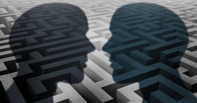 An illustration depicting the shadows of two heads on a maze