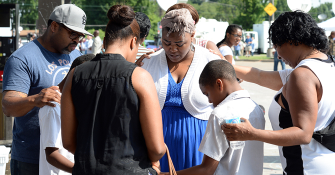 A group prays together in Ferguson, MO