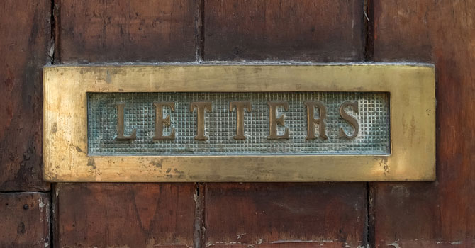 Mail slot in a door reads "LETTERS"
