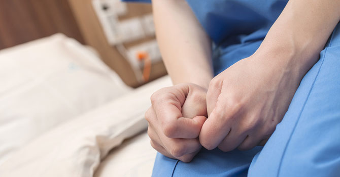 Close-up of hands of person in hospital
