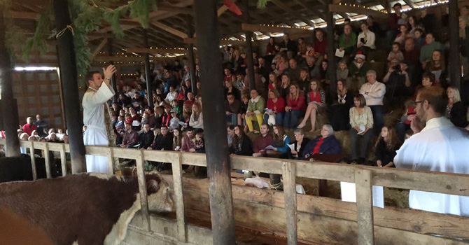 A Christmas Eve service being held inside a barn